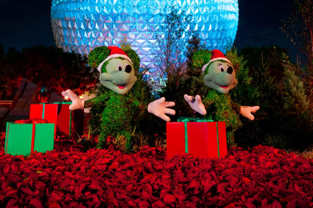 Mickey and Minnie holiday topiaries in front of Spaceship Earth at EPCOT